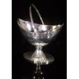 A George III Scottish silver boat-shaped sugar basket with engraved floral decoration to body,