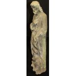A stone carving of bearded Saint holding scroll in his left hand with a cherub to his feet,
