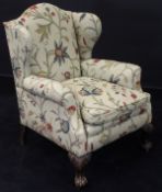 An early 19th Century wing back armchair with modern crewel work upholstery,