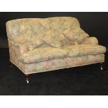 A Derwent floral upholstered two seat sofa in the Howard manner,