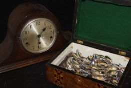 An oak cased Napoleon hat shaped mantle clock with Arabic numerals to the brushed steel dial,