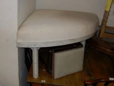 A corner stool in white fabric upholstered top,