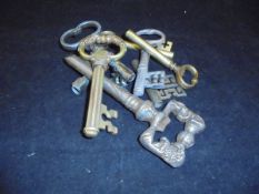 Six various brass and steel corkscrews in the form of large keys,