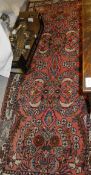 A Persian runner, the central panel set with repeating floral sprays,