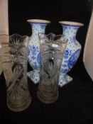 A pair of early 20th Century Continental blue and white decorated vases with foliate and medallion