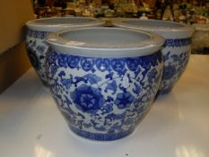 A set of three modern carp bowl style blue and white decorated jardiniers