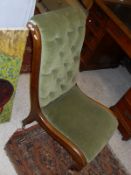 A Victorian nursing chair, the green velvet upholstery with button back and mahogany show frame,