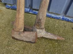 A wooden handled axe and a wooden handled pick axe