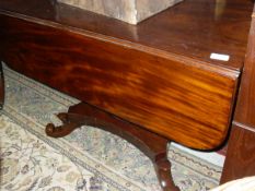 A 19th Century mahogany drop-leaf Pembroke table with single turned column to quatrefoil base with