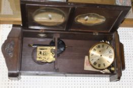 An oak cased wall clock with Roman numerals to the brushed steel dial