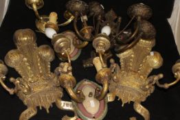 Two twin branch electric wall light fittings in a gilded finish, the back as fleur de lys,