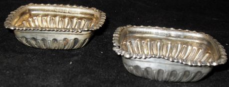 A pair of late Victorian silver embossed rectangular salts,
