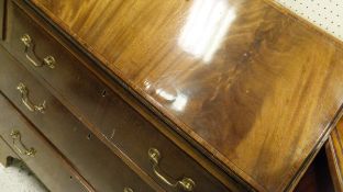 An early 20th Century mahogany and cross-banded bureau of three graduated drawers,