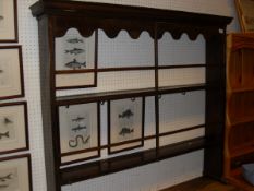 A 19th Century Scottish wall hanging plate rack with ogee moulded pediment above a shaped frieze