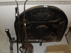 A cast iron fire back bearing date 1571, together with fire basket,