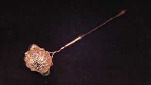 A 19th Century white metal punch ladle with turned wooden handle,