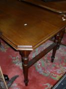 A Victorian teak folding table, raised on turned and ringed legs,