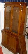 A 19th Century oak bookcase with moulded cornice with two glazed doors enclosing adjustable shelves