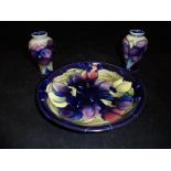 A pair of small Moorcroft Burslem pottery baluster shaped vases decorated in a "Pansy" pattern and