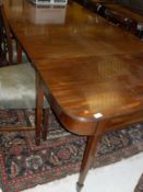 An early 19th Century mahogany D-end dining table with plain mahogany top,