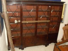 An early 20th Century mahogany break front bookcase in George III taste,