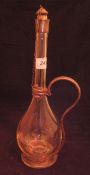 A liqueur decanter with white metal mounts,