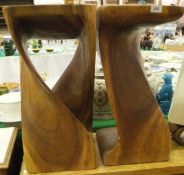 A pair of modern African carved hardwood square topped tables, the bodies of curving form,