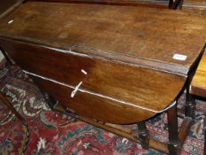 A 19th Century oak oval gate-leg table on turned supports to a stretchered base