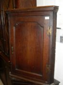 An early 19th Century oak corner cupboard,