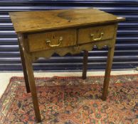 A 19th Century rectangular side table with two short drawers, shaped apron,