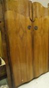 A mid 20th Century walnut twin-door wardrobe,