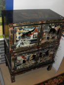 A 20th Century Chinese lacquered cabinet decorated with various figures in court scenes,