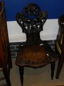 A late 19th Century Tyrolean hall chair with shield shaped back,