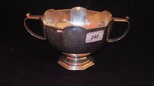 A George V silver twin-handled faceted bowl inscribed "Dr and Mrs Gregory from a few friends at