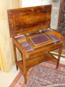 A Victorian rosewood writing desk, the rectangular top opening to reveal a writing slope,