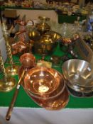 A brass preseve pan, brass candlesticks, various copper wares to include ewer, teapot, ladle, trays,