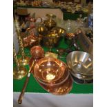A brass preseve pan, brass candlesticks, various copper wares to include ewer, teapot, ladle, trays,