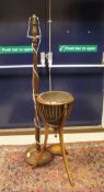 A 19th Century mahogany plant stand with brass liner, lion mask handles,
