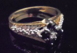An 18 carat gold diamond and sapphire dress ring