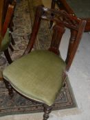 A set of six Victorian mahogany framed dining chairs with swept backs and green velvet plush