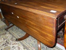 A 19th Century mahogany drop-leaf Pembroke table raised on a turned column to four legs and brass