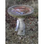 A composite stone bird bath on baluster support,