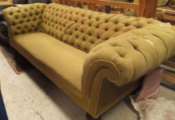 A three seater Chesterfield sofa in olive green button back upholstery,