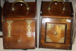 An oak coal scuttle with brass handle and brass decorations to the lift door,