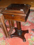 A Victorian rosewood teapoy, the rising top opening to reveal a fitted interior,