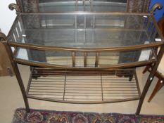 A bronze effect and glass hall table with two glazed tiers over a metal undertier,