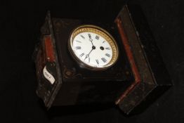 A black and red marble mantle clock with Roman numerals to the enamelled dial,