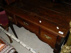 A George III oak lowboy of three drawers,