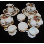 A Royal Albert "Country Roses" part tea set comprising twelve cups and saucers, two jugs,