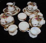 A Royal Albert "Country Roses" part tea set comprising twelve cups and saucers, two jugs,